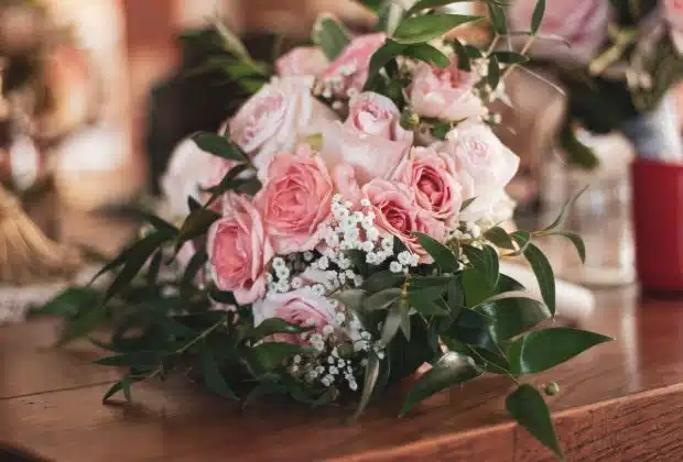 pink roses on brown wooden table